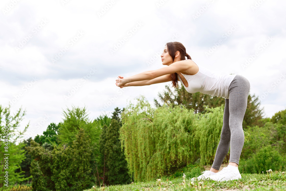 Young sportive woman leaning in park Young sportive woman leaning in park