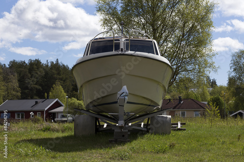 boat on a trailer in front of some houses photo