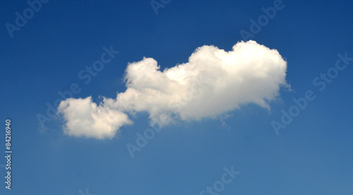 Single cloud in the blue summer sky photo