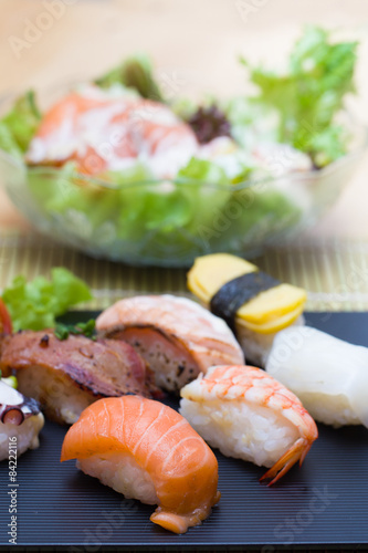 Sushi assortment on black dish, close up