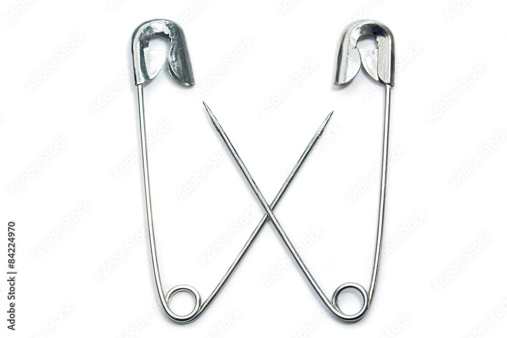 two safety pins cross their arms, isolated on white two safety pins cross their arms, isolated on white