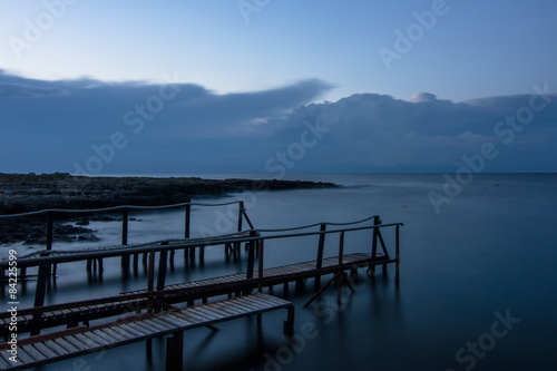 Long exposure: a wooden pier after sunset in a blu autumn sky © Alessandro Scagliusi