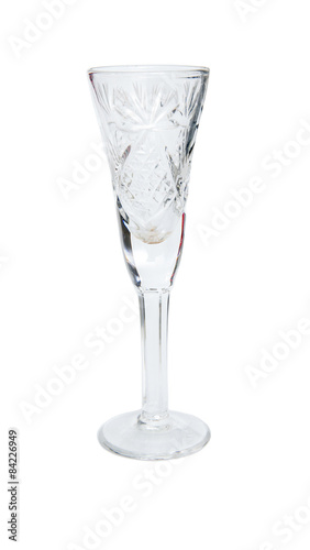 Empty crystal glass with notches on a white background