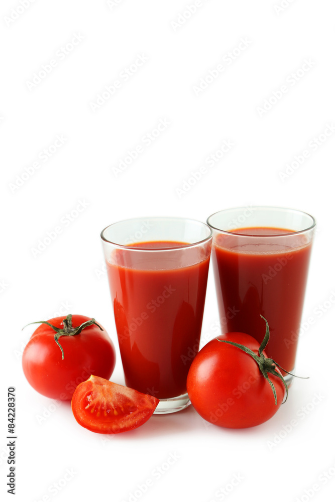 Fresh red tomatos and tomato juice in glass isolated on white Fresh red tomatos and tomato juice in glass isolated on white
