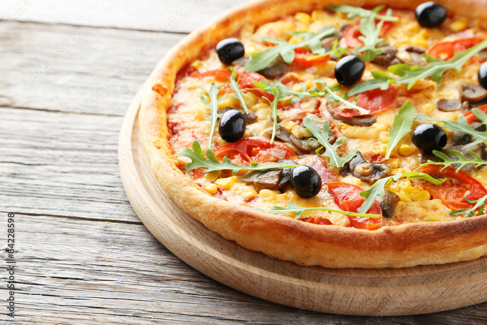 Fresh tasty pizza on grey wooden background