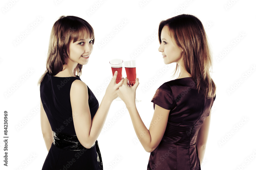 Two young beautiful fashion women with a wine glasses Two young beautiful fashion women with a wine glasses