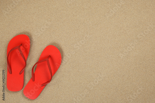 Flip Flops Sandalen im Sand und Urlaub mit Textfreiraum photo