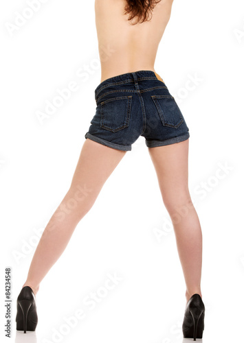 Shirtless woman in jeans shorts.