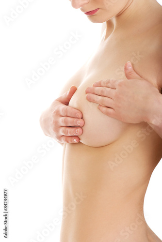 Fotografija Woman examining breast.