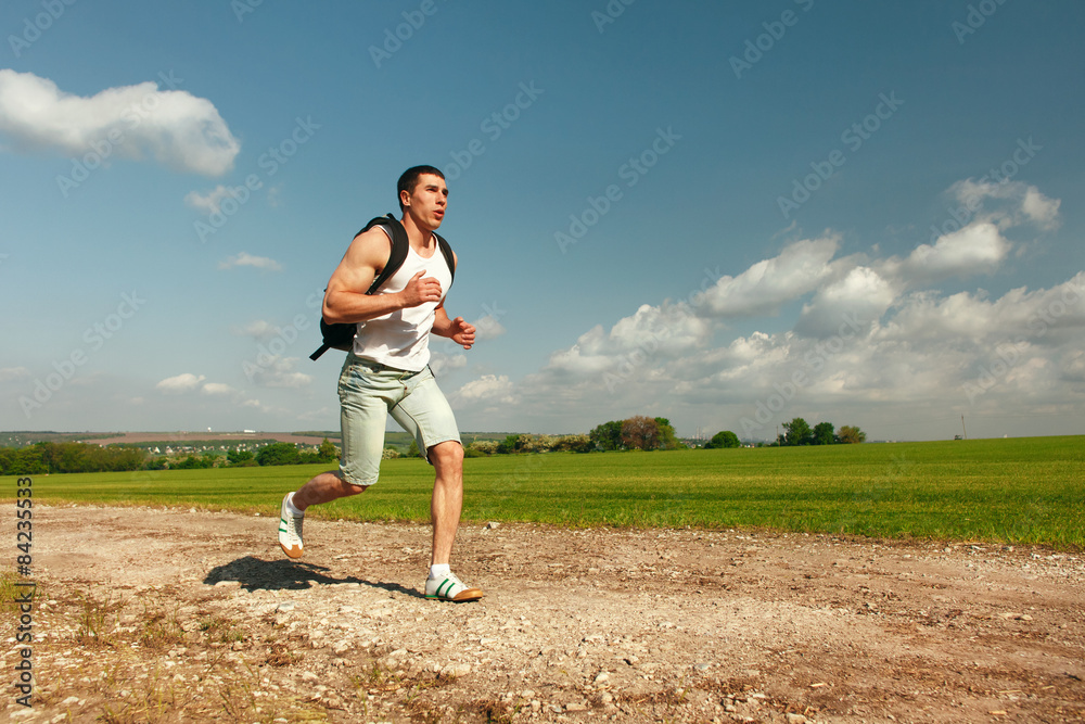 Running man sprinting cross on a trail. Male fit sport fitness Running man sprinting cross on a trail. Male fit sport fitness