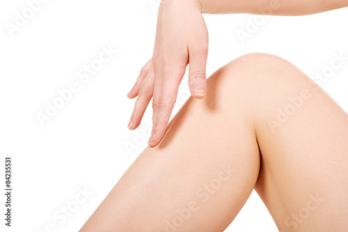 Woman touching her leg.