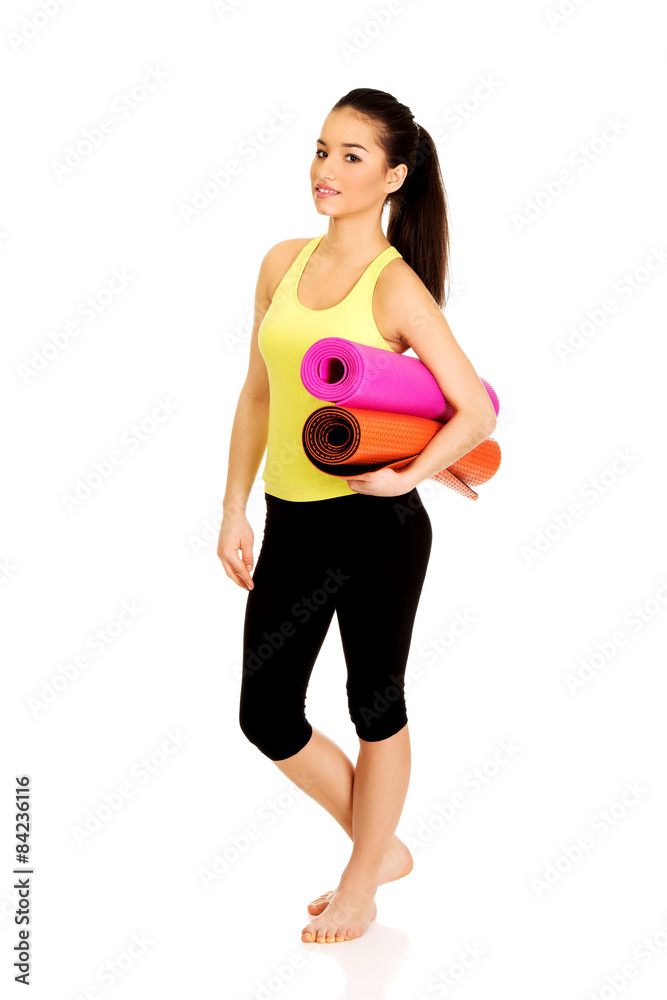 Fitness woman ready holding yoga mats. Fitness woman ready holding yoga mats.