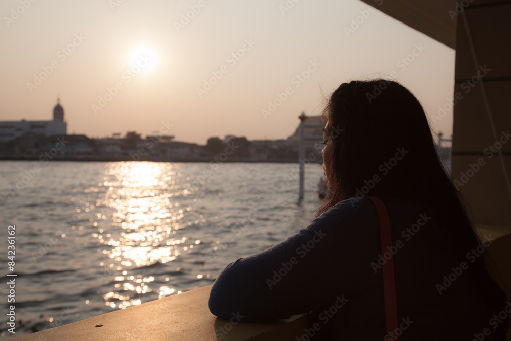 Silhouette portrait woman near river.