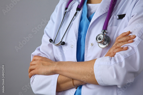 Young woman doctor standing  with crossed arms