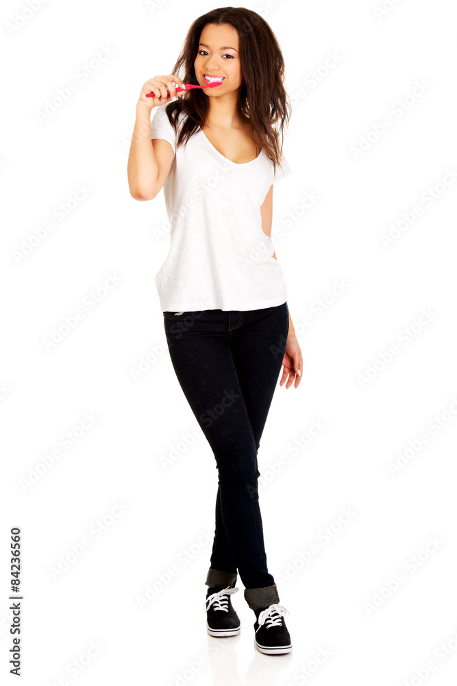 Fototapeta premium Beautiful teen brushing her teeth.