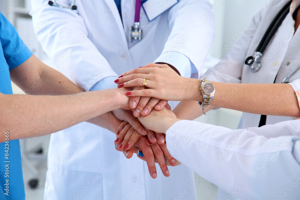 Doctors and nurses in a medical team stacking hands Doctors and nurses in a medical team stacking hands