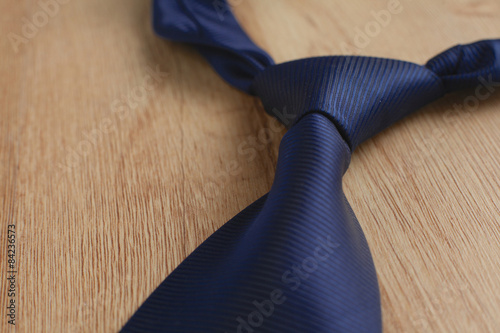 Elegant blue tie on a wooden background 