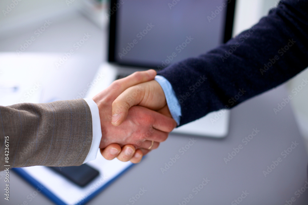 Closeup of a business handshake, on white background Closeup of a business handshake, on white background
