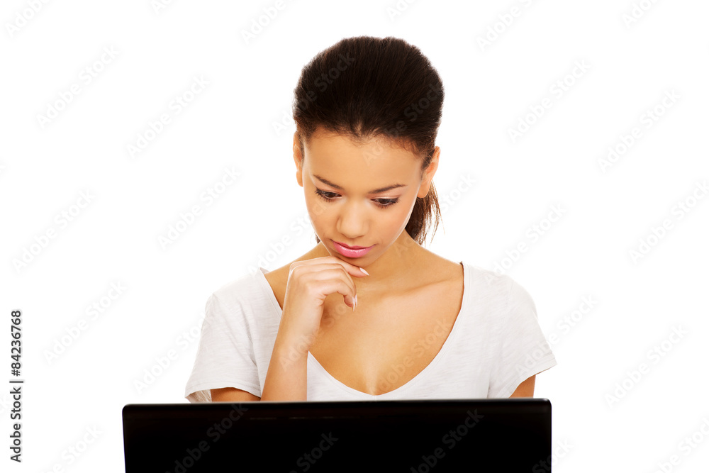 Teen woman using a laptop. Teen woman using a laptop.