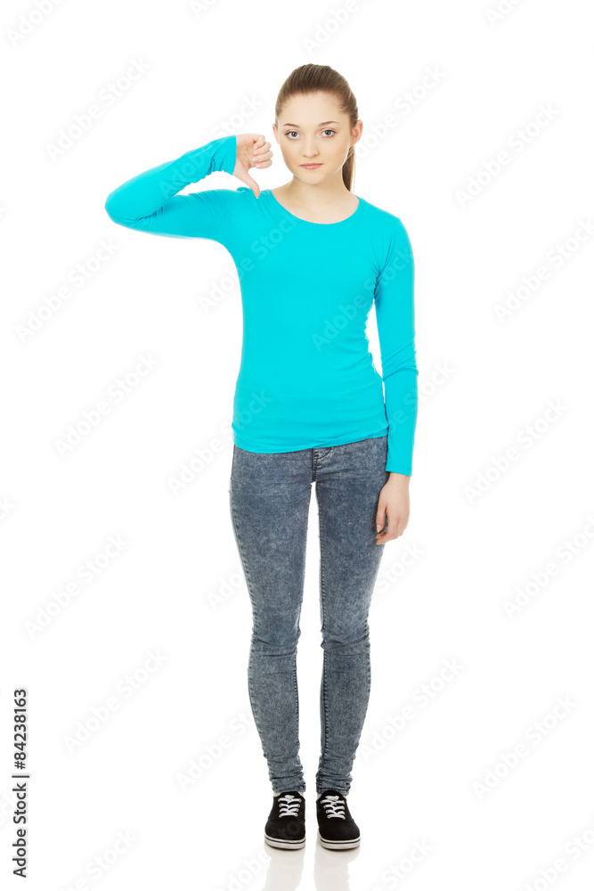 Young woman with thumbs down. Young woman with thumbs down.