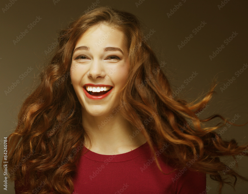 Young happy woman with wind in hair 
