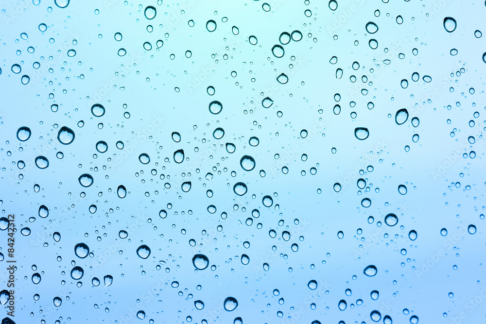 Water drop on glass mirror background.