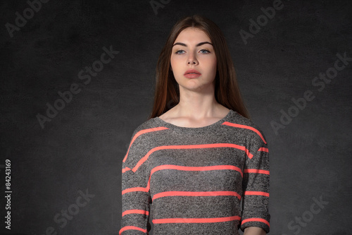 Girl shows sadness against the dark background