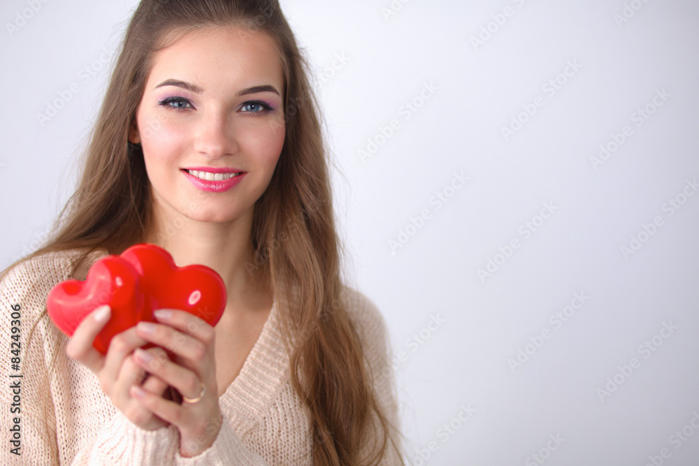 Portrait of beautiful happy woman holding a symbol heart. 