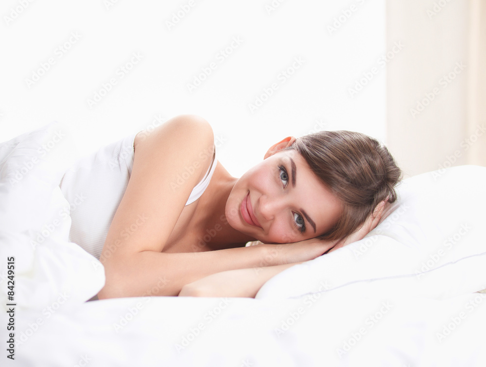 Beautiful girl lying in bedroom at early morning 