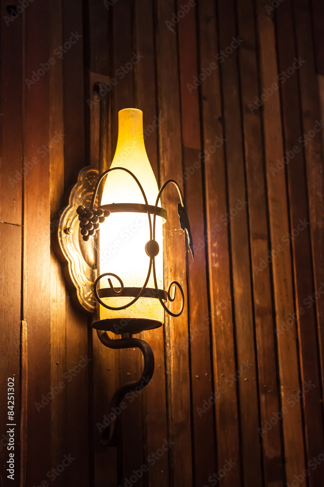 Lamp hanging on  wooden wall
