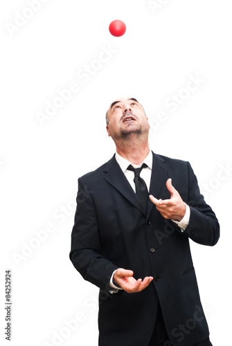 Businessman that is juggling with a red balls
