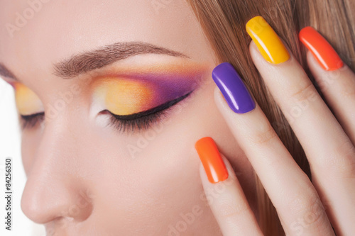 Blond young woman with manicure and make-up