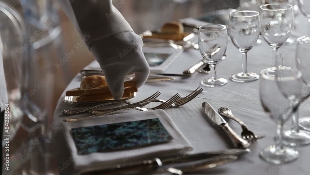 Waiter set the table for dinner in exclusive and luxury restaurant Waiter set the table for dinner in exclusive and luxury restaurant