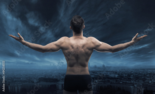 Muscular man looking at the town photo