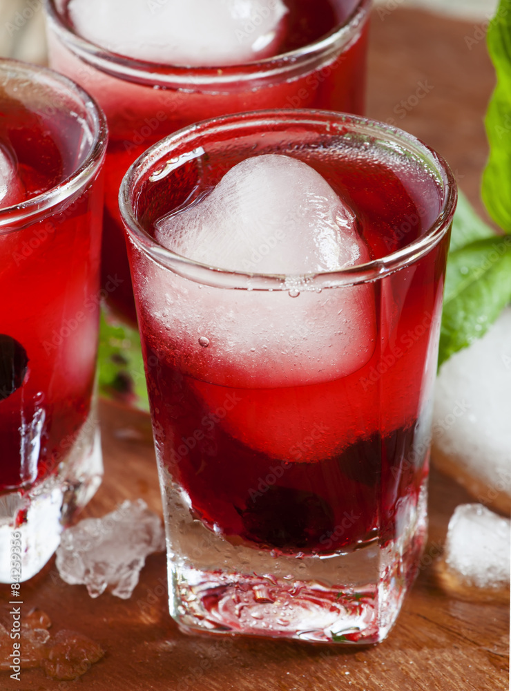 Red berry juice with ice in the shape of hearts, selective focus Red berry juice with ice in the shape of hearts, selective focus