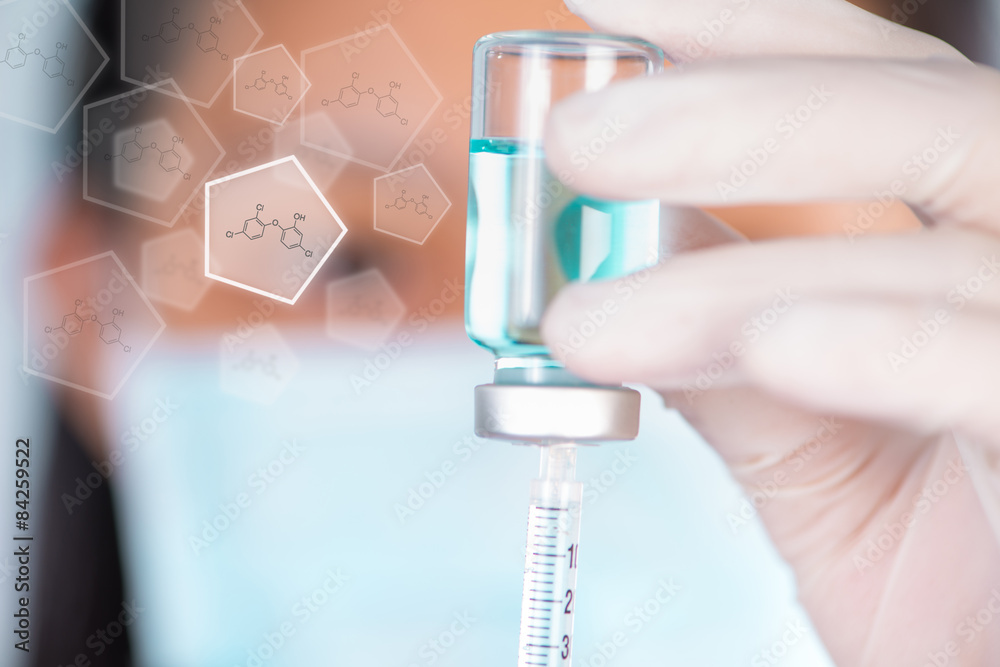 Closed up Nurse fills syringe from injection vial and chemical s Closed up Nurse fills syringe from injection vial and chemical s