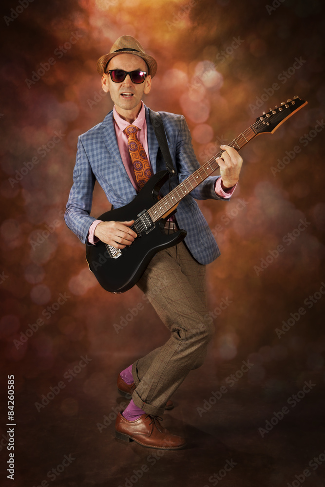Fototapeta premium Rockabilly man playing the guitar