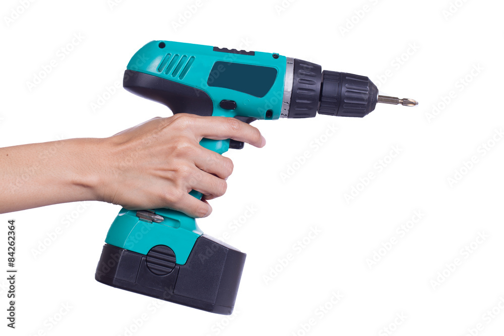 Hand with cordless screwdriver or drill isolated on a white back Hand with cordless screwdriver or drill isolated on a white back