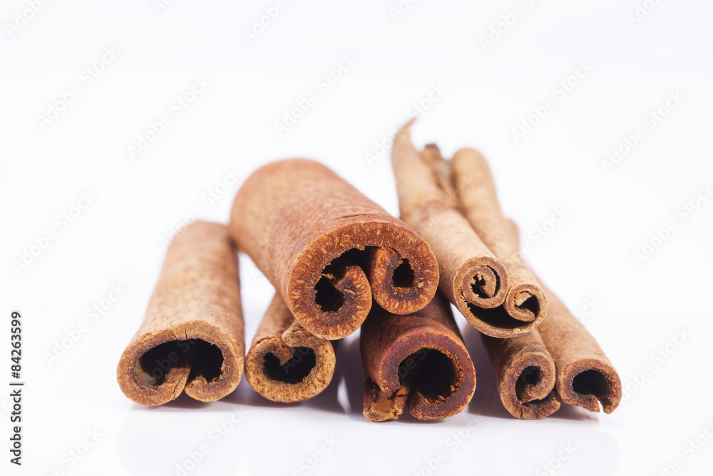group of dried cinnamon stics on white background group of dried cinnamon stics on white background