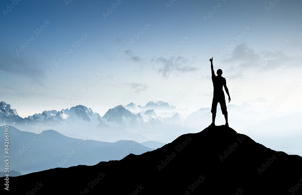 Winner silhouette on the mountain peak Winner silhouette on the mountain peak