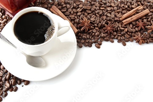 Coffee cup with beans at the top on white photo