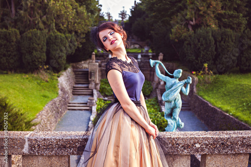 Portrait of brunette in veil by the balustrade in the castle gar photo