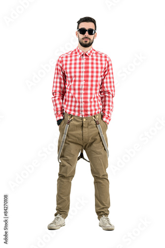 Man in retro clothes standing with hands in pockets