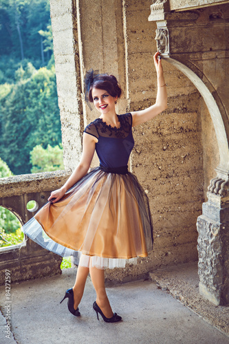 Tablou pe pânză Young refined lady on the balcony of the castle