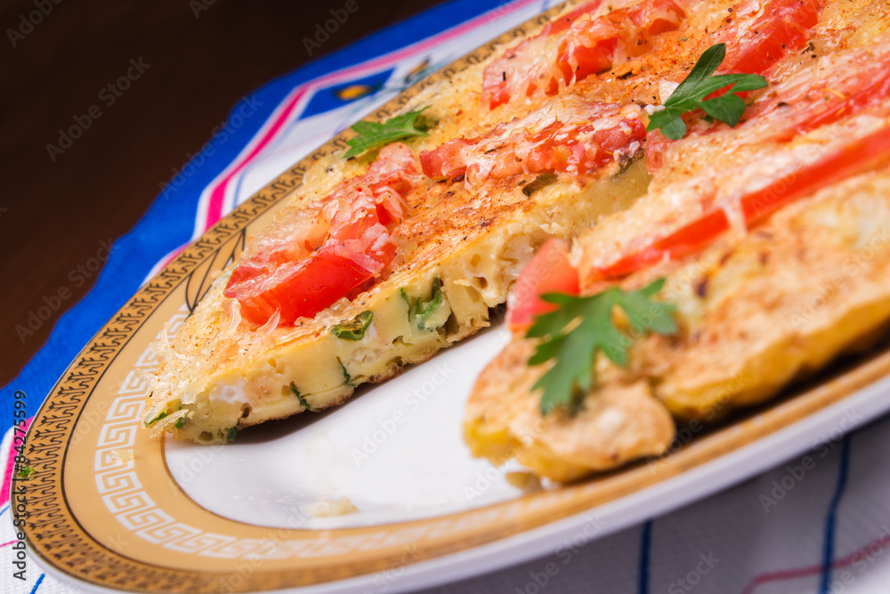 Omelet with cauliflower, tomatoes, fresh herbs and cheese 