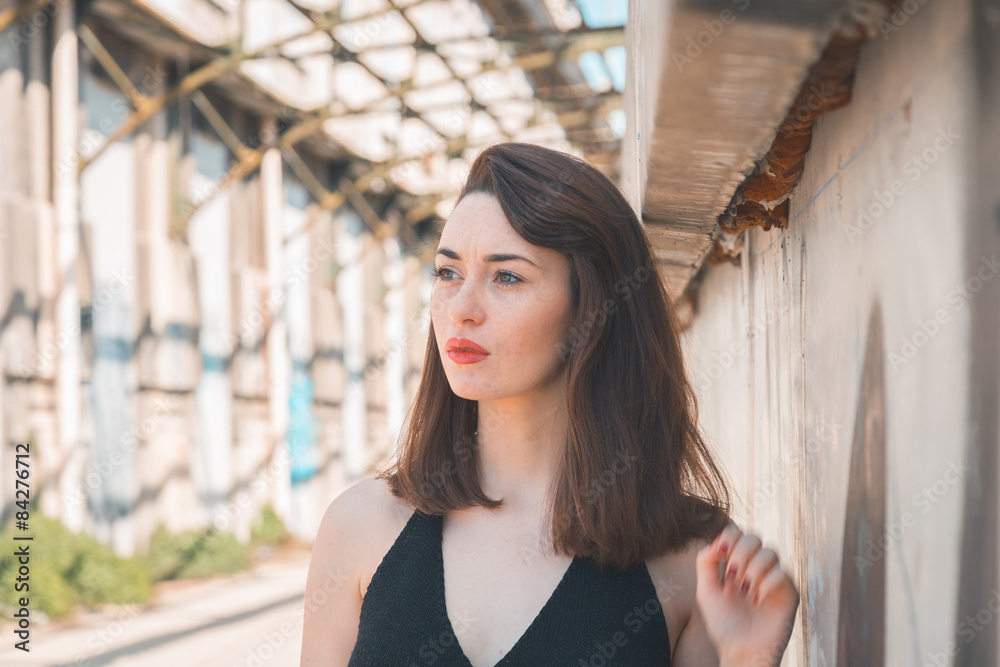 Fototapeta premium Beautiful brunette posing in an industrial context