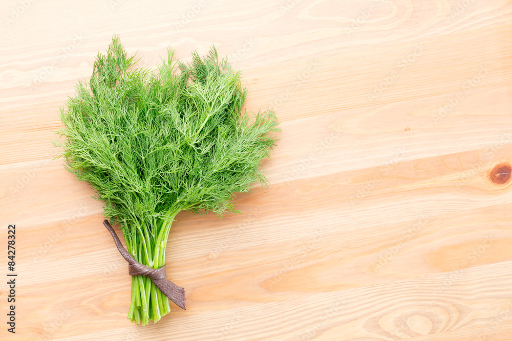 Fresh dill on a light wooden background Fresh dill on a light wooden background