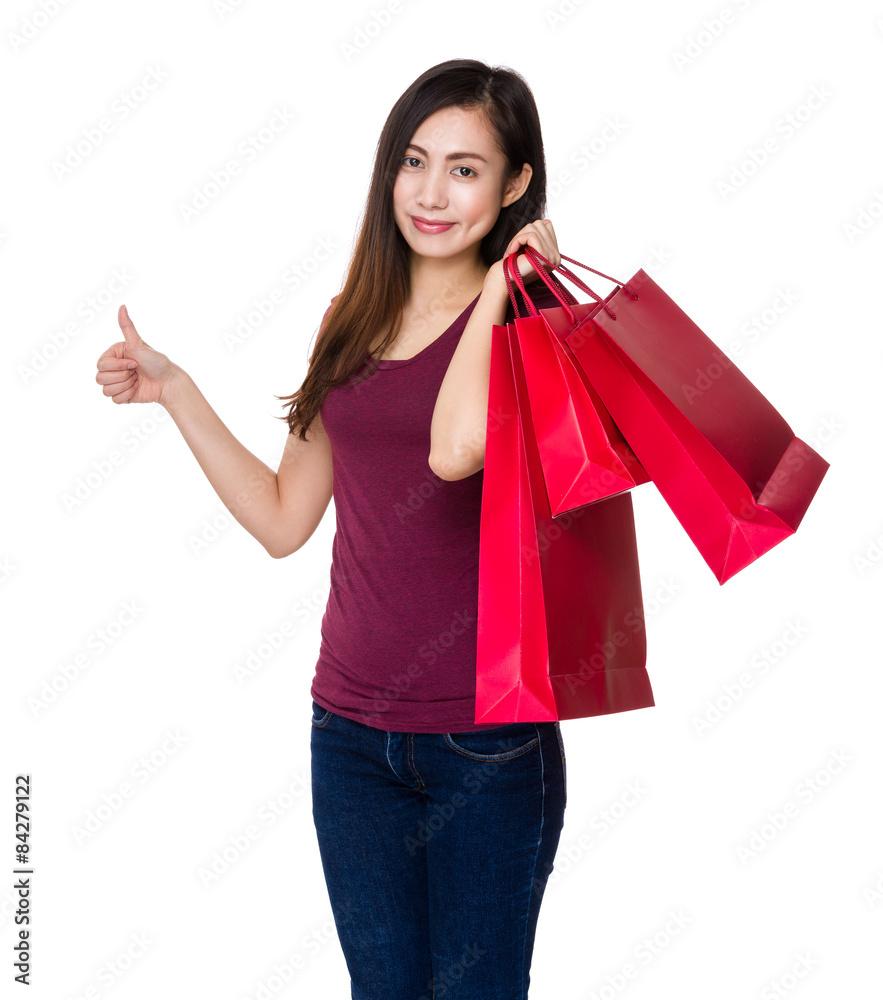 Asian woman hold with shopping bag and thumb up Asian woman hold with shopping bag and thumb up