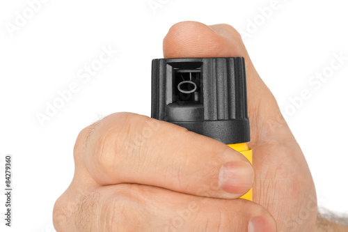 Hand with bottle of pepper spray photo