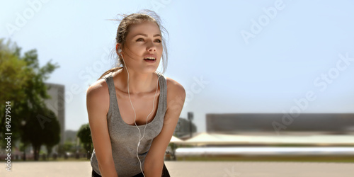Girl at the time of exercise is listening to music